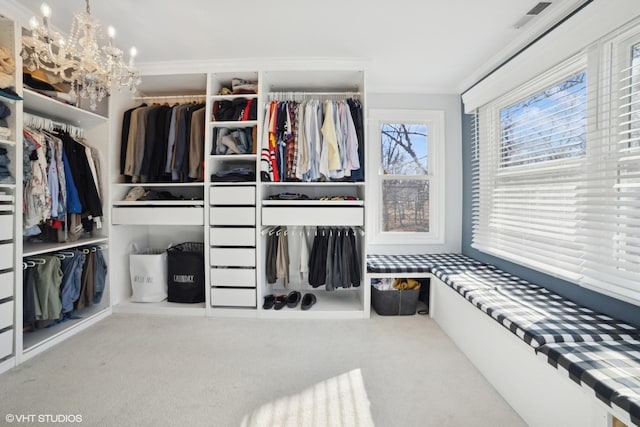 spacious closet with carpet floors and a notable chandelier