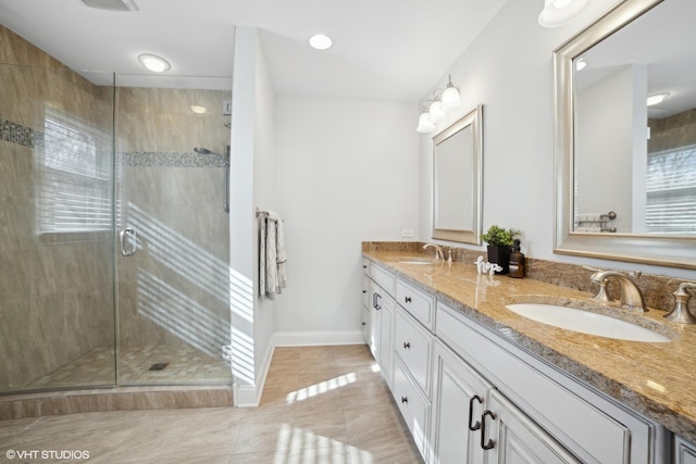 bathroom featuring walk in shower, tile patterned floors, and vanity