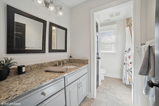 bathroom featuring vanity, toilet, and tile patterned flooring