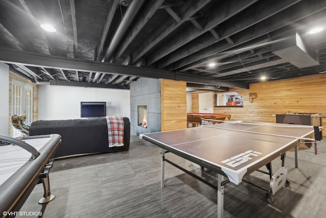 playroom featuring wooden walls and dark hardwood / wood-style flooring