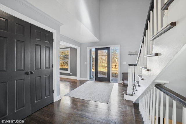 entryway with french doors, dark hardwood / wood-style floors, and a high ceiling