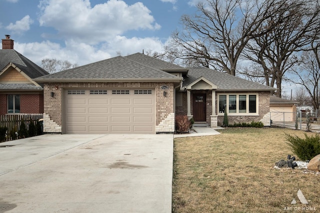 view of front of home with a garage and a front lawn