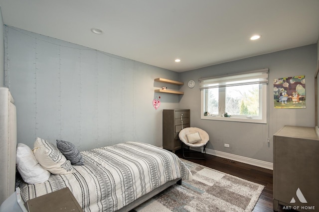 bedroom with dark hardwood / wood-style floors