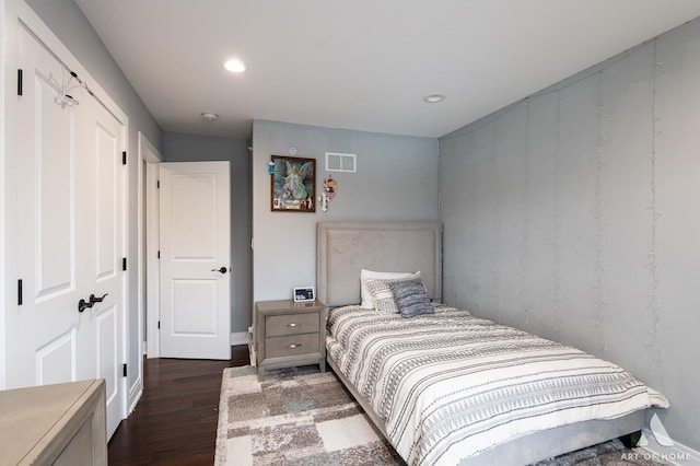 bedroom with dark wood-type flooring