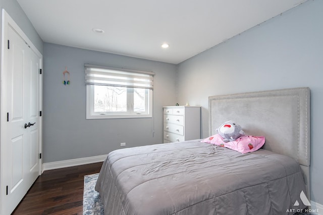 bedroom with dark hardwood / wood-style flooring