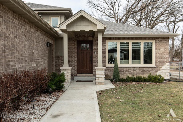 view of exterior entry featuring a lawn