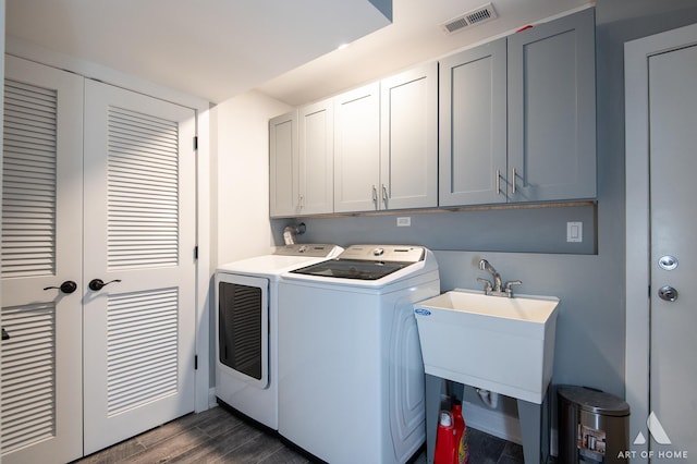 washroom with french doors, sink, cabinets, dark hardwood / wood-style floors, and washer and clothes dryer