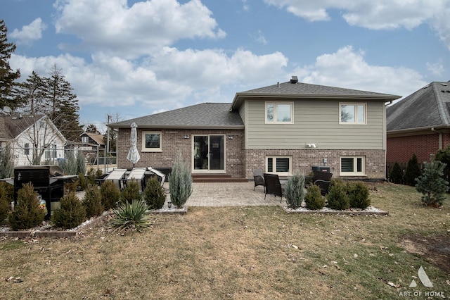 back of house with a patio area and a lawn