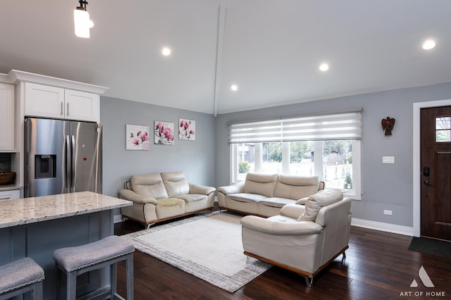 living room featuring a healthy amount of sunlight, dark hardwood / wood-style flooring, and vaulted ceiling