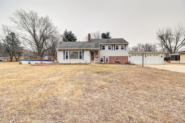 split level home featuring a garage and a front yard