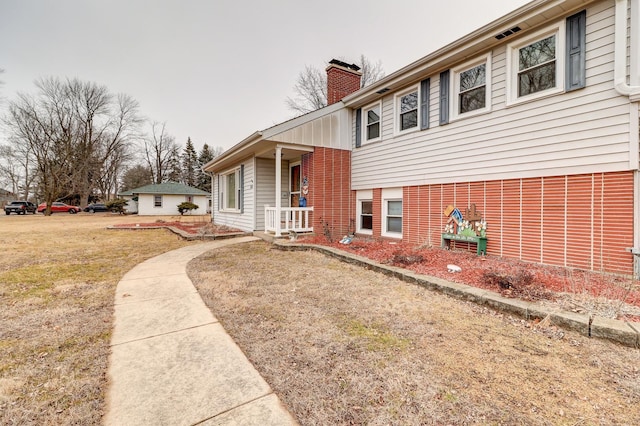 view of side of home featuring a lawn