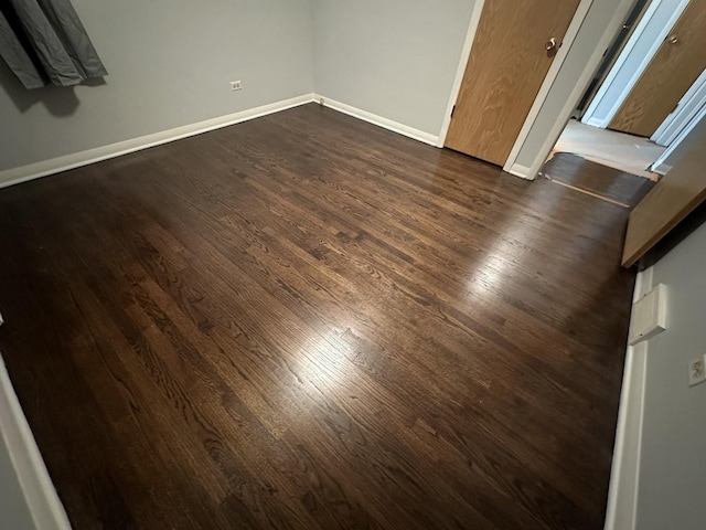 unfurnished bedroom with dark hardwood / wood-style flooring