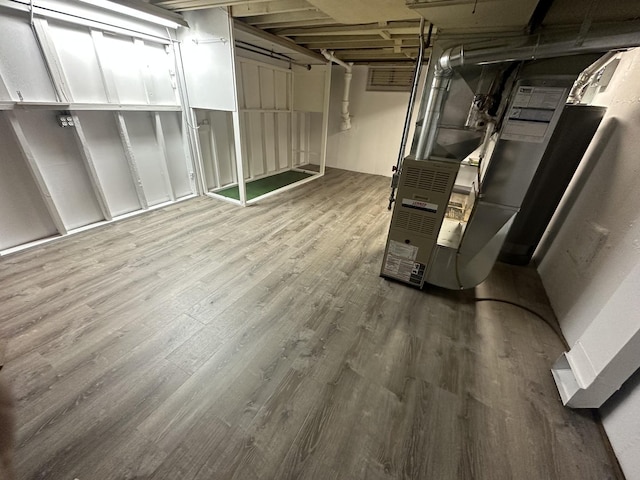 basement with hardwood / wood-style floors