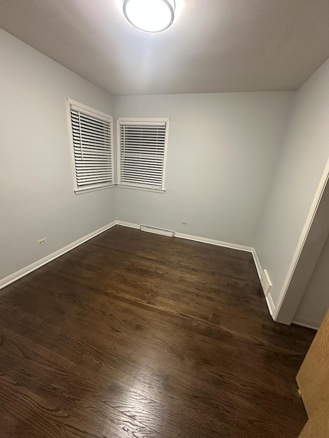 spare room featuring dark wood-type flooring