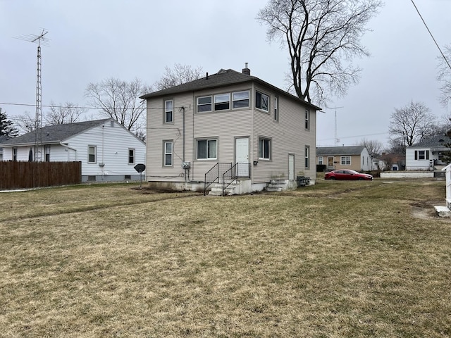 back of house featuring a lawn