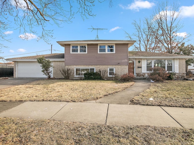 split level home featuring a garage and a front yard