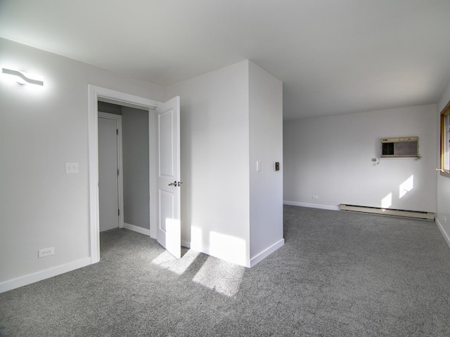 carpeted empty room with a baseboard heating unit and a wall mounted AC