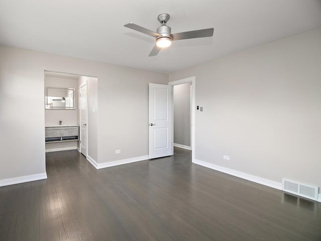 unfurnished bedroom featuring dark hardwood / wood-style floors, ceiling fan, and ensuite bath