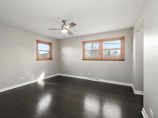 unfurnished room with dark wood-type flooring and ceiling fan