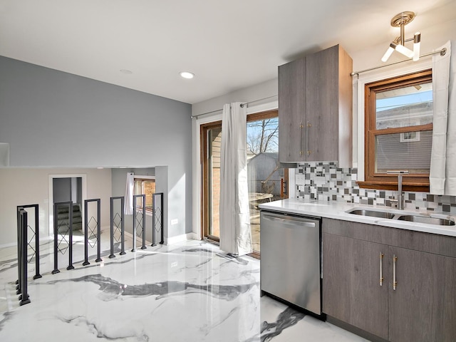 kitchen with tasteful backsplash, dishwasher, sink, and dark brown cabinets