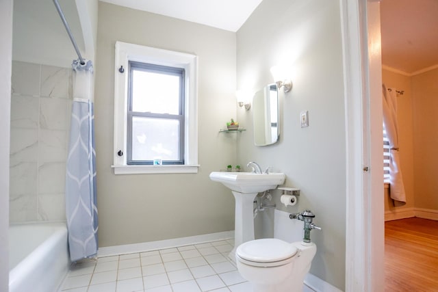 bathroom with toilet, tile patterned flooring, and shower / tub combo