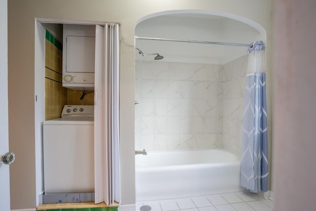 bathroom featuring shower / tub combo, tile patterned flooring, and stacked washer and clothes dryer