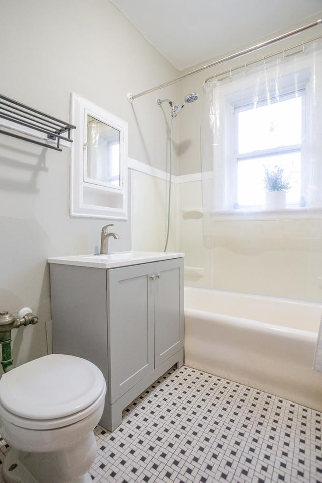 full bathroom featuring tile patterned flooring, vanity, toilet, and shower / tub combination