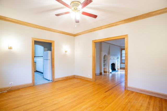 unfurnished room with crown molding, ceiling fan, and light wood-type flooring