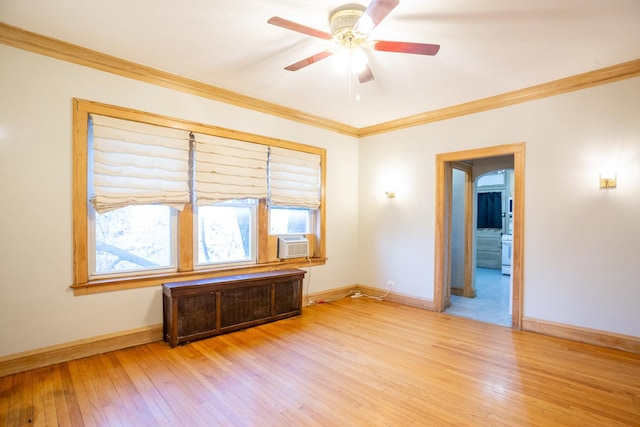 empty room featuring cooling unit, radiator, light hardwood / wood-style flooring, and ornamental molding