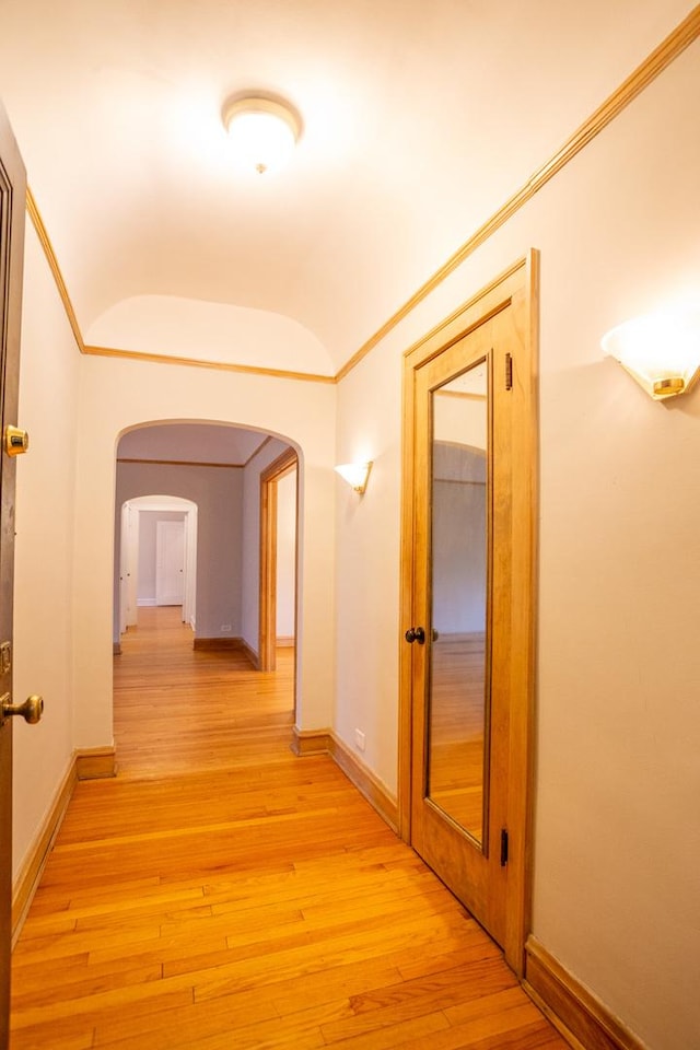 hall featuring ornamental molding and light wood-type flooring