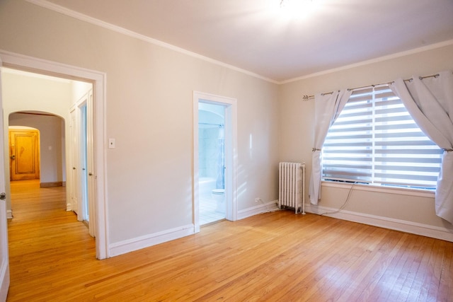 unfurnished room with radiator, crown molding, and light hardwood / wood-style floors