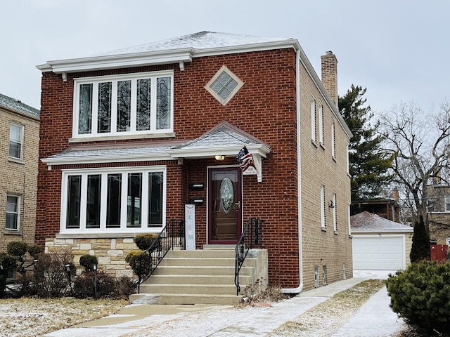 view of front of house with a garage and an outbuilding