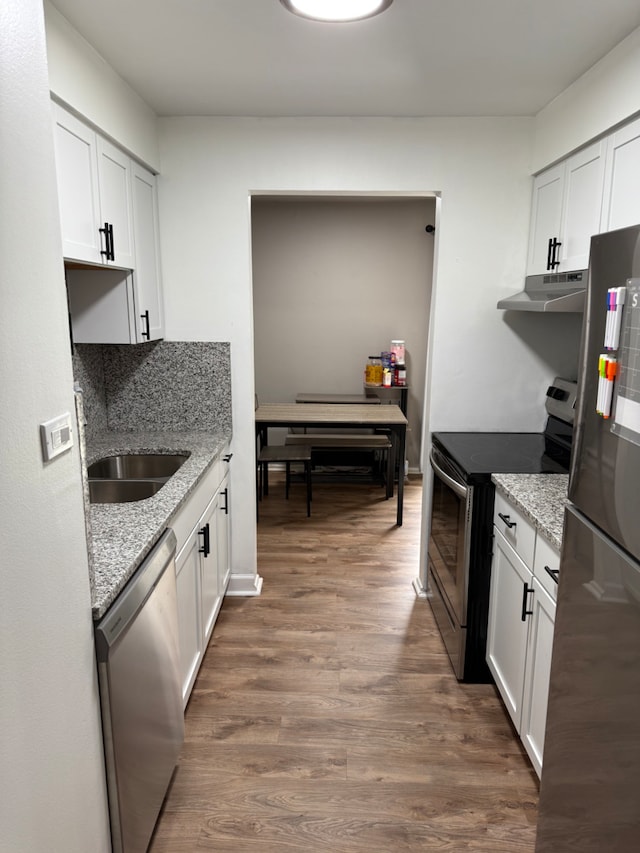 kitchen featuring stainless steel appliances and white cabinets