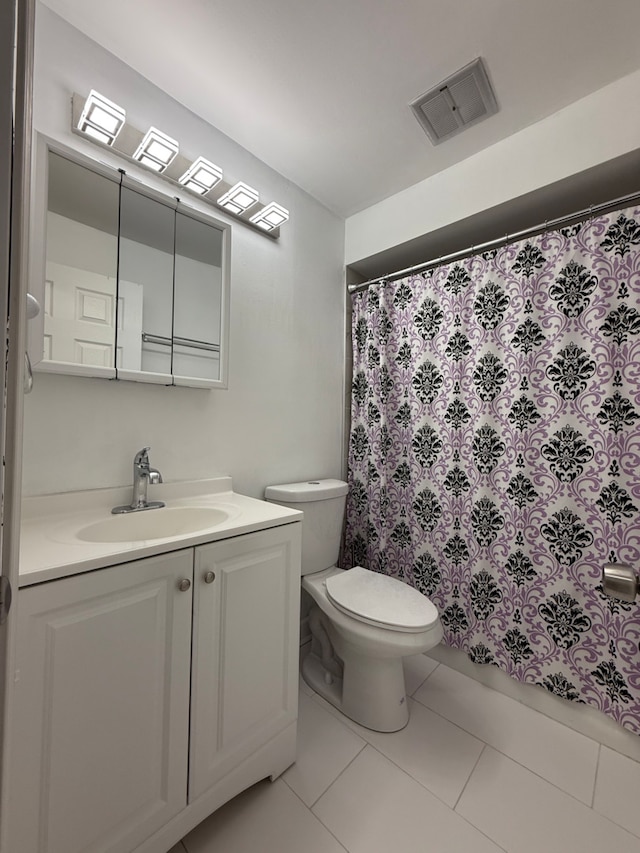 bathroom with tile patterned floors, vanity, and toilet