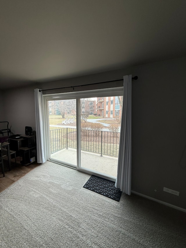 unfurnished living room featuring carpet flooring and a wealth of natural light