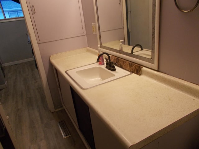 bathroom featuring vanity and hardwood / wood-style floors