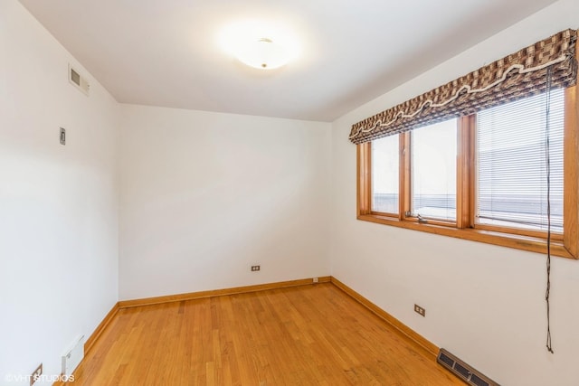 unfurnished room with hardwood / wood-style floors