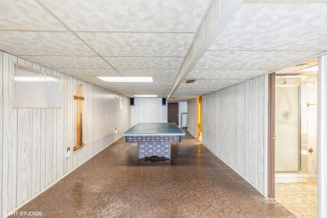 recreation room with wooden walls