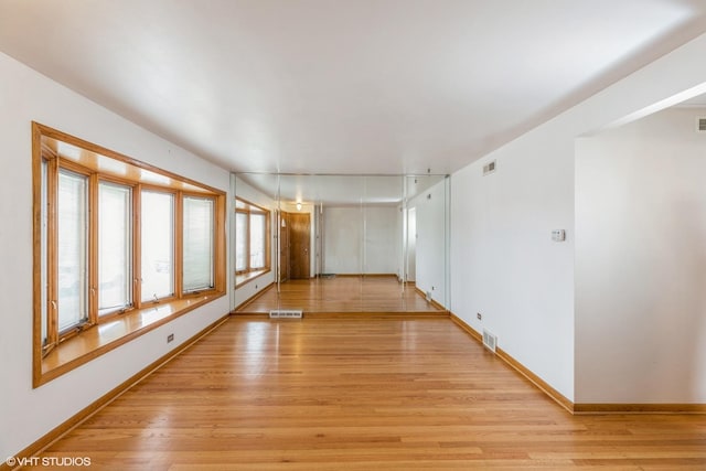 unfurnished room with light wood-type flooring