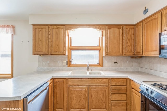 kitchen with gas stove, sink, stainless steel dishwasher, and backsplash