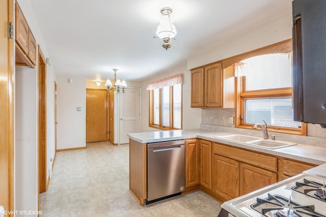 kitchen featuring dishwasher, white gas range, sink, hanging light fixtures, and kitchen peninsula