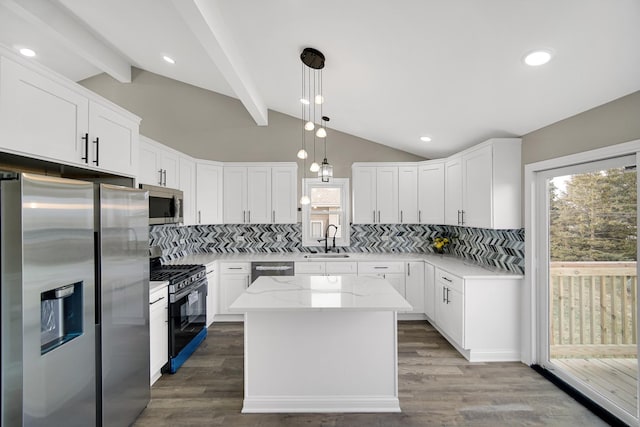 kitchen with a kitchen island, pendant lighting, white cabinetry, sink, and stainless steel appliances