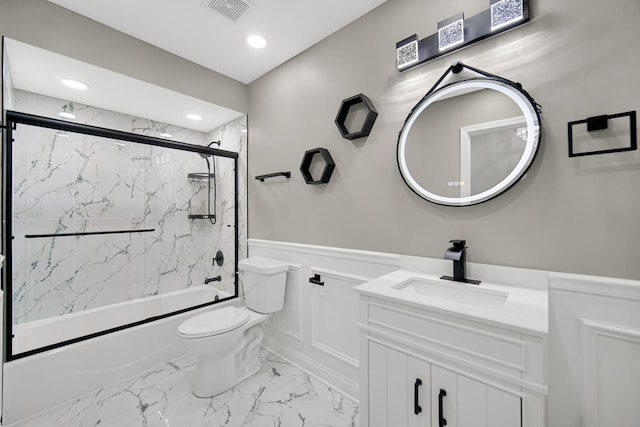 full bathroom with vanity, enclosed tub / shower combo, and toilet