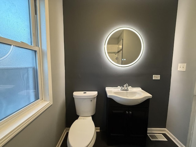 bathroom featuring vanity and toilet