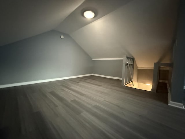 additional living space with lofted ceiling and dark wood-type flooring