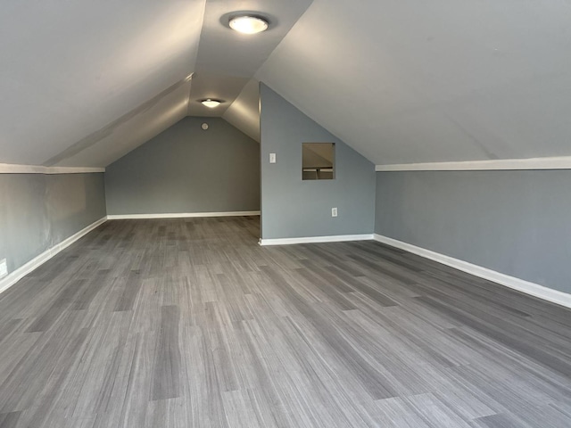 bonus room featuring hardwood / wood-style floors and vaulted ceiling