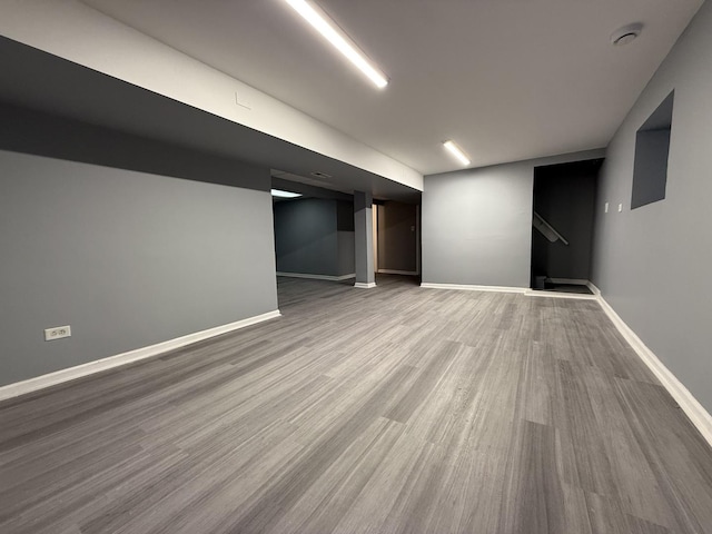 basement with hardwood / wood-style floors