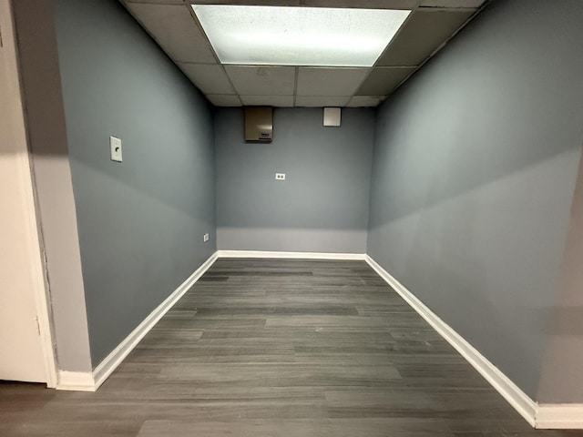 interior space featuring wood-type flooring and a drop ceiling