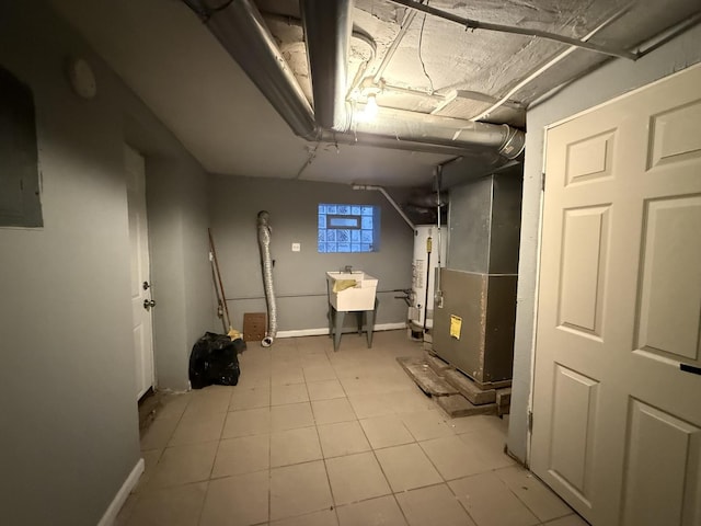 basement with sink and light tile patterned flooring