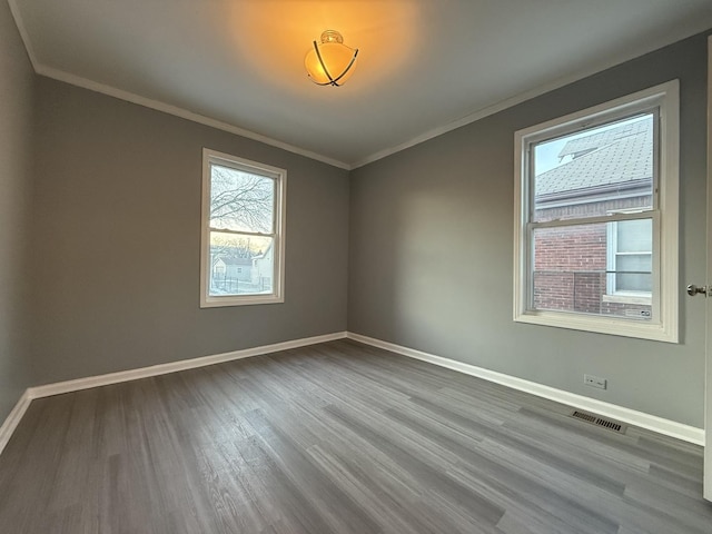 spare room with crown molding and hardwood / wood-style floors